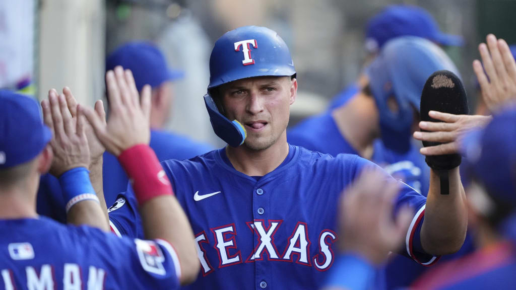 a Texas Rangers baseball player in a blue uniform