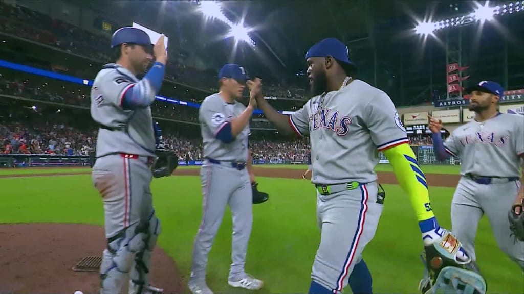 a group of Texas Rangers baseball players high fiving each other