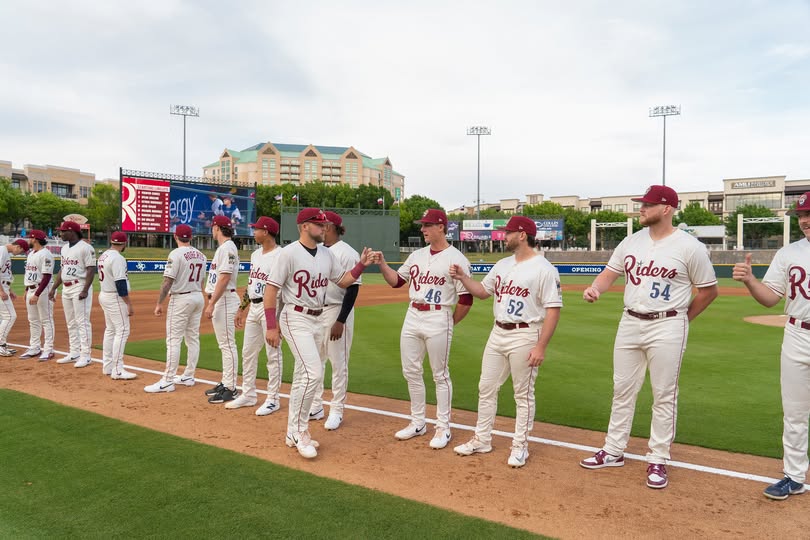 Frisco RoughRiders Baseball players lined up on field