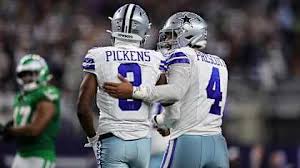 George Pickens Two NFL Dallas Cowboys football players in uniforms