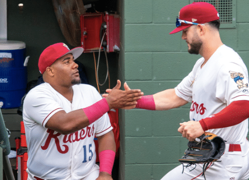 Two MiLB Riders baseball players greeting each other