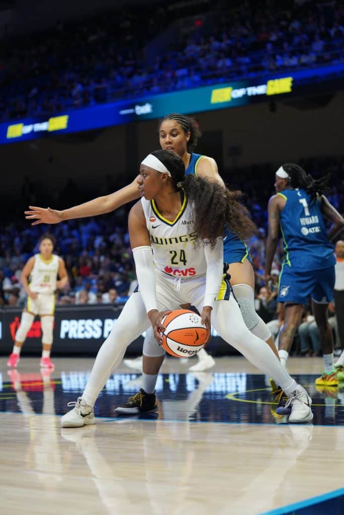 Arike Ogunbowale WNBA Basketball players competing for possession.