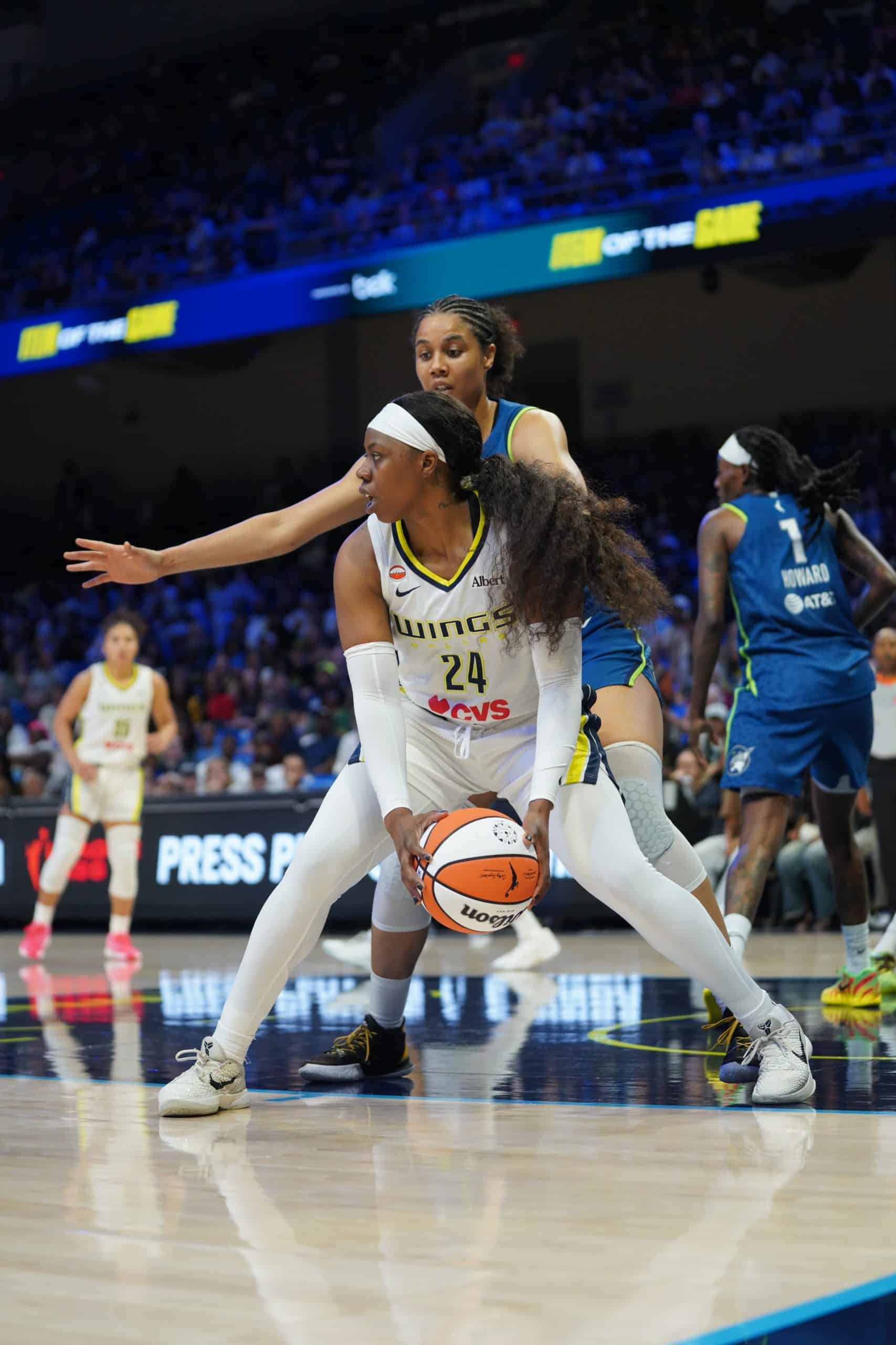 Arike Ogunbowale WNBA Basketball players competing for possession.