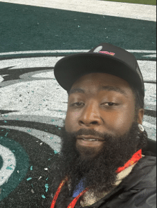 Man smiling on football field